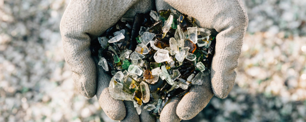 gloves hands holding glass particles